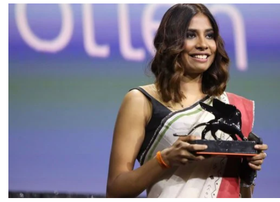 Anuparna Roy receiving Best Director award at Venice Film Festival, celebrating her filmmaking achievemen